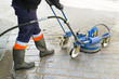 © GDM photo and video - power water washing by  worker of professional service in city street