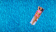 © Dmytro Flisak - Woman in bikini on the inflatable mattress in the swimming pool.