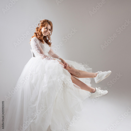 Charming Girl In Magnificent Wedding Dress And White Sneakers