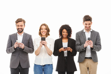 Wall Mural - Group of smiling young business people using mobile phones