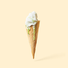 Wall Mural - cone of ice cream with syrup, on a yellow background