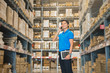 © Sirichai - Portrait Of Manager In Warehouse. wholesale, logistic, people and export concept . Business owner Using Tablet Computer In Distribution Warehouse.