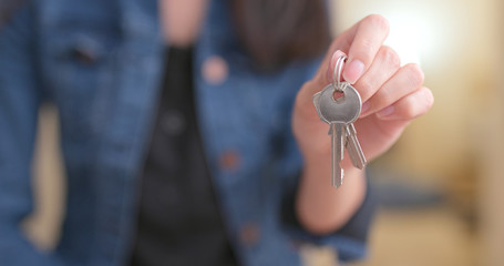 Woman holding key at home