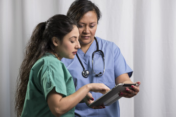 Medical staff looking at information on a hand held device