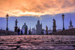 Charles Bridge in the old town of Prague at sunrise with cobble stone pavements and dramatic sky