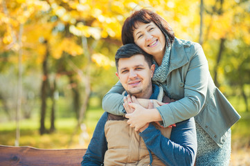 Loving happy mature mother hugging adult son in beautiful sunny park. Mother Day Lifestyle People Love Family concepts