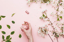 Perfume Water In Woman Hand With Spring Blossom. Top View On Pink Isolated Background, Flatlay.