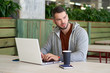 © EverGrump - Pensive freelancer in sportswear working on a new project in the cafe.