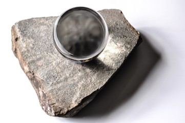 Wall Mural - Crystal ball on a stone fragment on white
