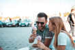 © Nebojsa - Happy couple is eating ice creams while they sitting outdoors