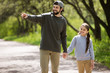 © LIGHTFIELD STUDIOS - smiling father pointing by finger to daughter in park