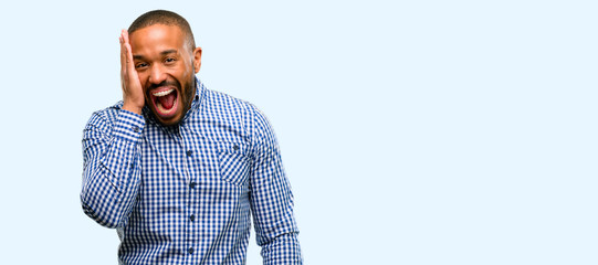 Poster - African american man with beard so happy and confident showing a big smile surprised finger isolated over blue background