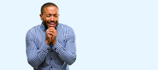 Canvas Print - African american man with beard crying depressed full of sadness expressing sad emotion isolated over blue background