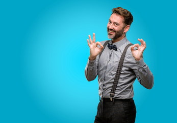 Canvas Print - Middle age man, with beard and bow tie doing ok sign gesture with both hands expressing meditation and relaxation