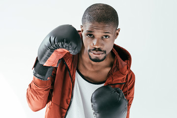 Wall Mural - handsome african american man in boxing gloves, isolated on white