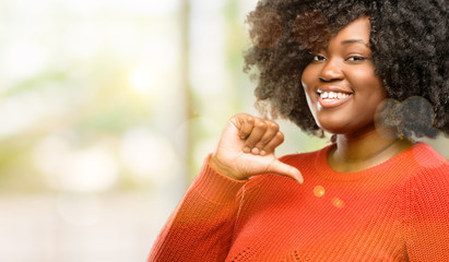 Poster - Beautiful african woman proud, excited and arrogant, pointing with victory face, outdoor