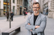© contrastwerkstatt - Street portrait of mature man with arms crossed
