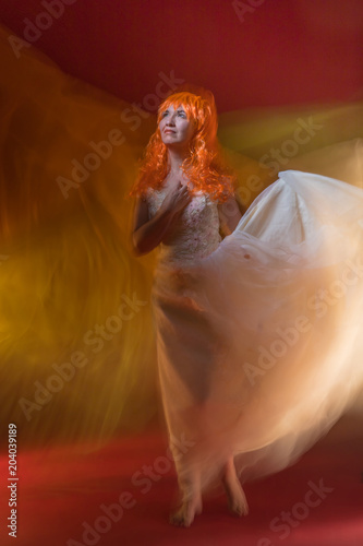 Old Female Actress With Orange Hair Dancing In White Dress With