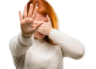 Sticker - Beautiful young redhead woman stressful and shy keeping hand on head, tired and frustrated isolated over white background