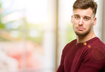 Sticker - Handsome young man with sad and upset expression, unhappy