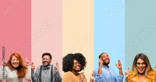 Cool group of people, woman and man with crossed fingers asking for good luck Tableau sur Toile