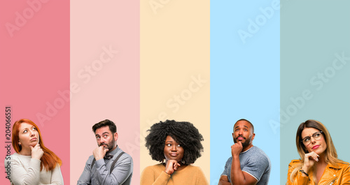 Fotografía Cool group of people, woman and man thinking and looking up expressing doubt and