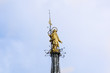 The Madonnina atop Milan Cathedral at the height of 108.5 m in Milan, italy. Milan Duomo is the largest church in Italy. Historical architecture of Milan. Golden Madonna on the blue sky background.