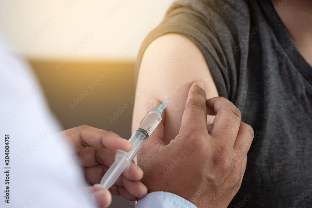 Medicine and health care concept Doctor giving patient vaccine insulin or vaccination - obrazy, fototapety, plakaty 