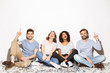 © Drobot Dean - Group of happy multiracial people sitting on a floor