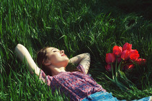 Portrait Of A Young Woman Lying On The Grass .Girl Resting In The Park