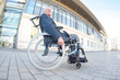 © auremar - elderly man in wheelchair alone outdose large building