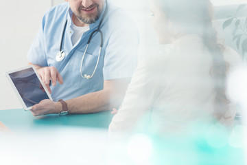 Surgeon showing information on tablet