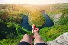 Person sitting on a peak and relaxing. Nature of Czech Republic and sightseeing called Vyhlídka Máj. Vltava river. 