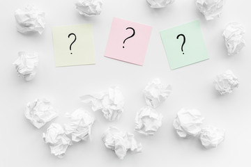 Poster - FAQ concept. Question mark on sticky notes near crumpled paper on white background top view