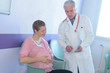 © auremar - male doctor with pregnant woman in hospital