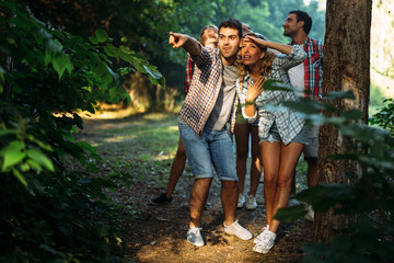Wall Mural - beautiful woman and friends hiking in forest