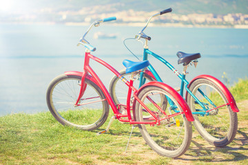 Two bright bicycles on the background of the sea