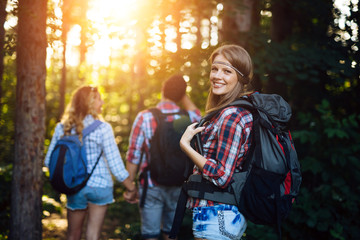 Wall Mural - beautiful woman and friends hiking in forest