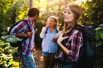 Wall Mural - group of backpacking hikers going for forest trekking