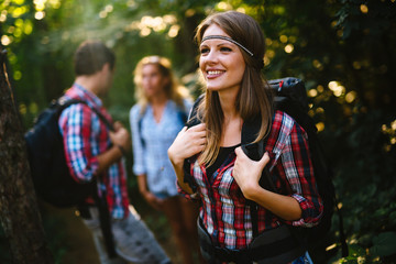 Wall Mural - group of people hiking in forest