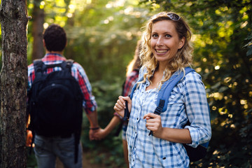 Wall Mural - group of backpacking hikers going for forest trekking