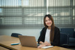 © reewungjunerr - Beautiful asian woman working at the office  in the evening,Thailand worker writing book in the company