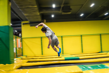 Wall Mural - trampoline jumper performs complex acrobatic exercises and somersault on the trampoline.