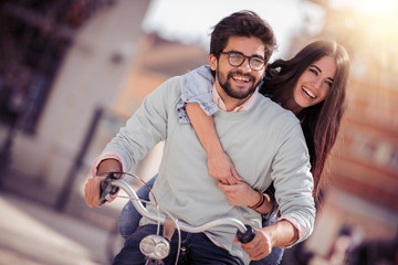 Canvas Print - Couple riding on bicycle and having fun