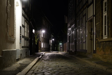   Tiny street with old nordic style houses at night in the town of Goslar, Germany in the Harz region.