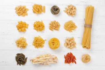 Various pasta on white wooden table