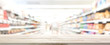 Wood table top with blur supermarket in background, panoramic banner