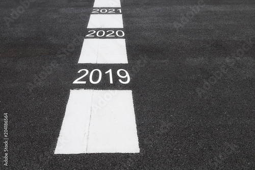 Poster Number of 2019 to 2021 on asphalt road surface with marking lines, happy new yea