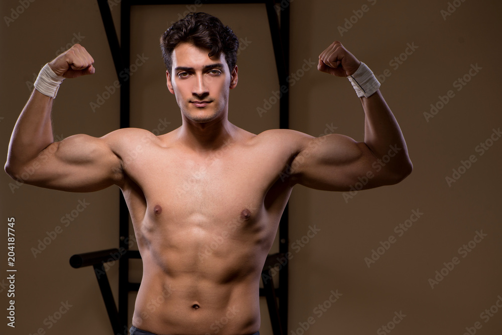 Ripped muscular man in gym doing sports Stock Photo | Adobe Stock