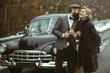 © Volodymyr - Travel and business trip or hitch hiking. Retro collection car and auto repair by mechanic driver. Escort of girl by security. Couple in love on romantic date. Bearded man and sexy woman in fur coat.